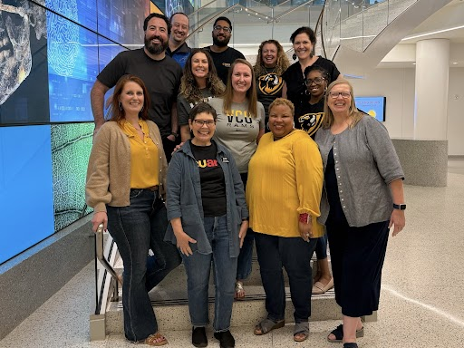 Members of the VCU Alumni Council stand on the stairs at the STEM Building