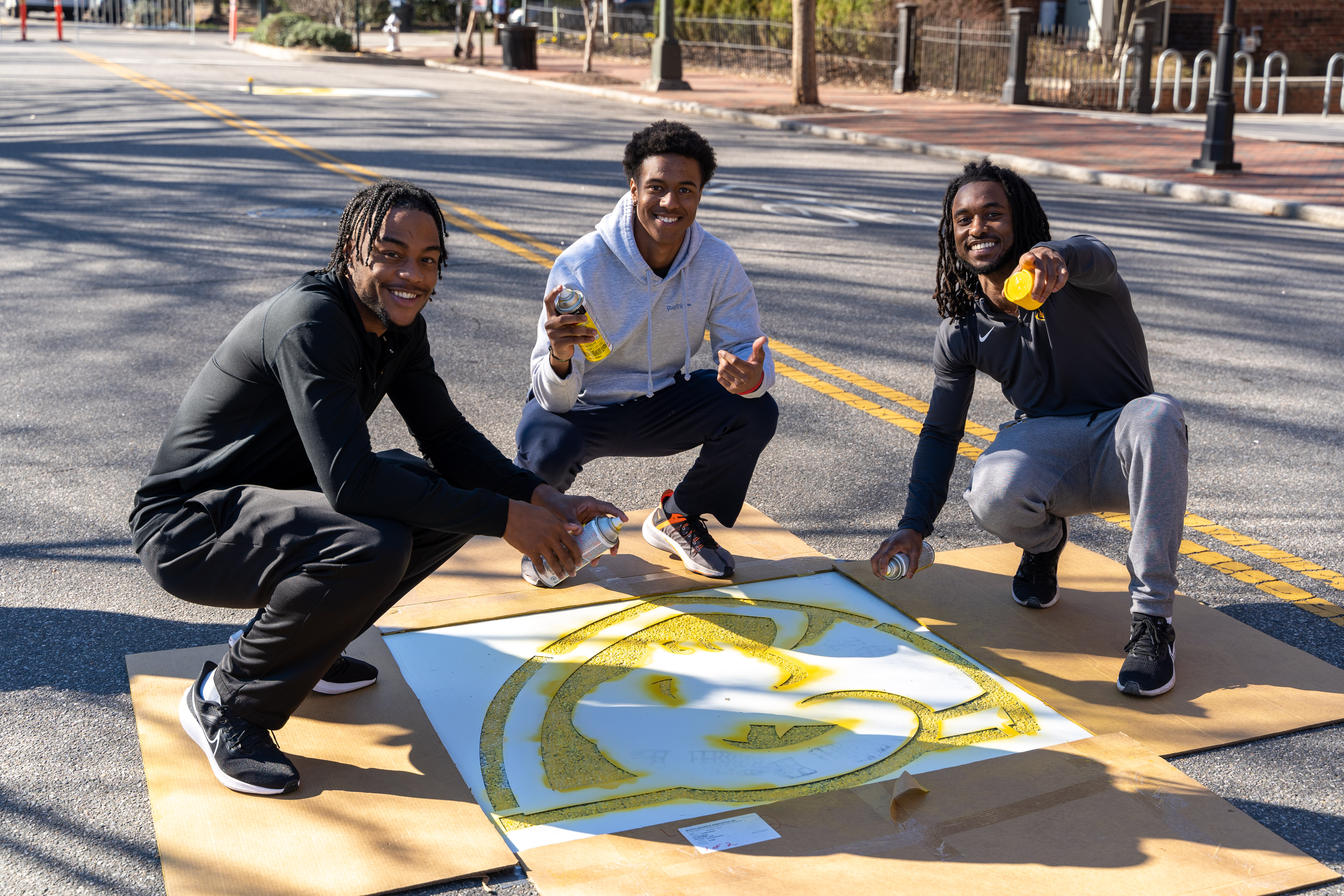 Students on Franklin Street painting the VCU spirit mark