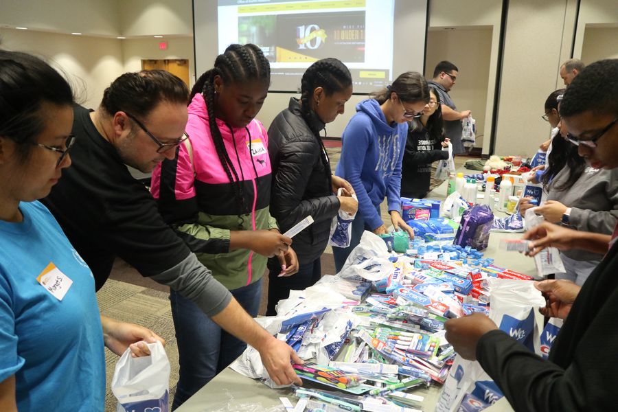 Volunteers pack dental hygiene kits.