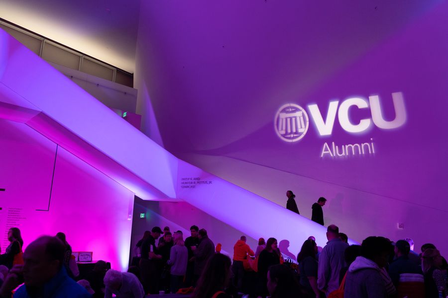 A crowd of people inside an art museum.