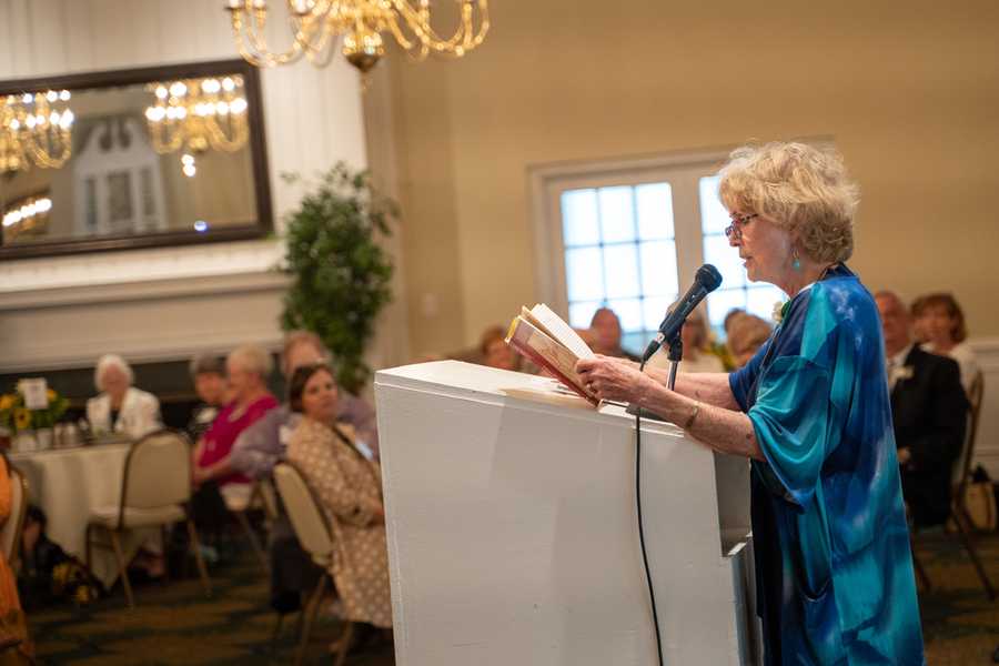 An author reads from her book at a podium.