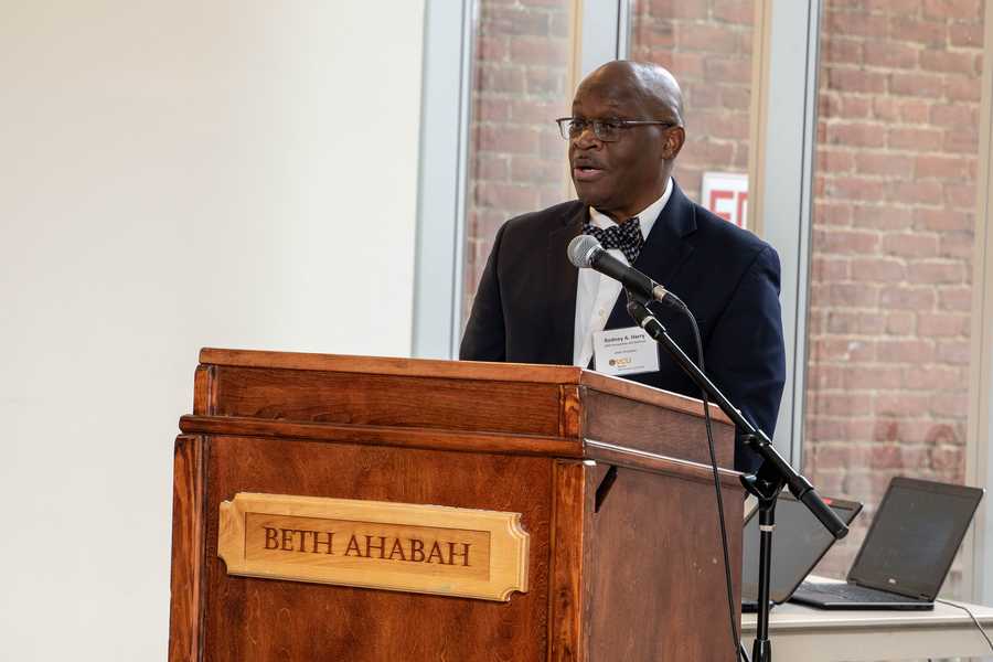 A man speaks to a crowd from a podium.