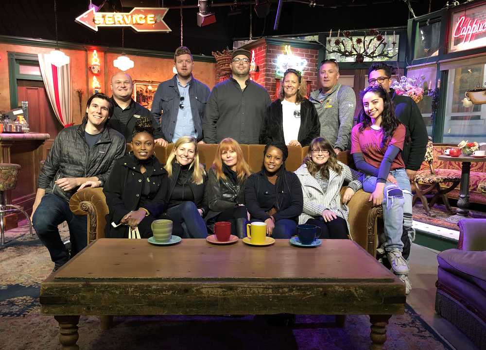 A group of V-C-U alumni and staff pose for a photo inside Warner Brothers studios.