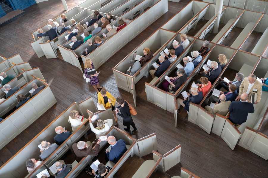 People sit on church pews