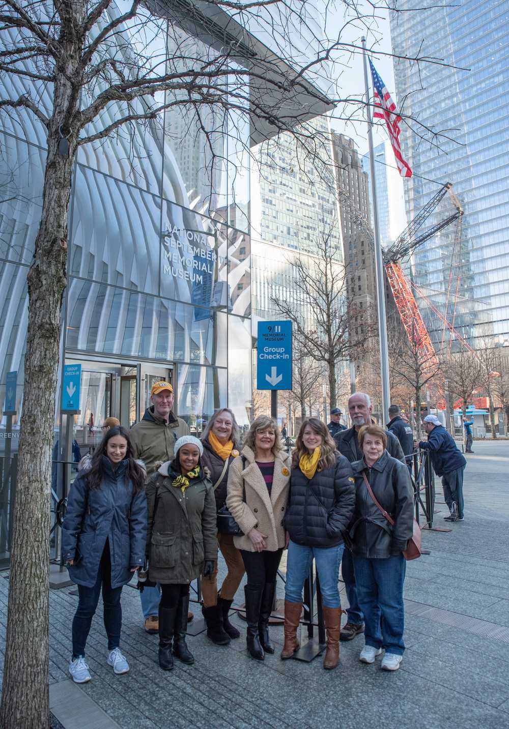 A group of people stands for a photo on the streets of New York.
