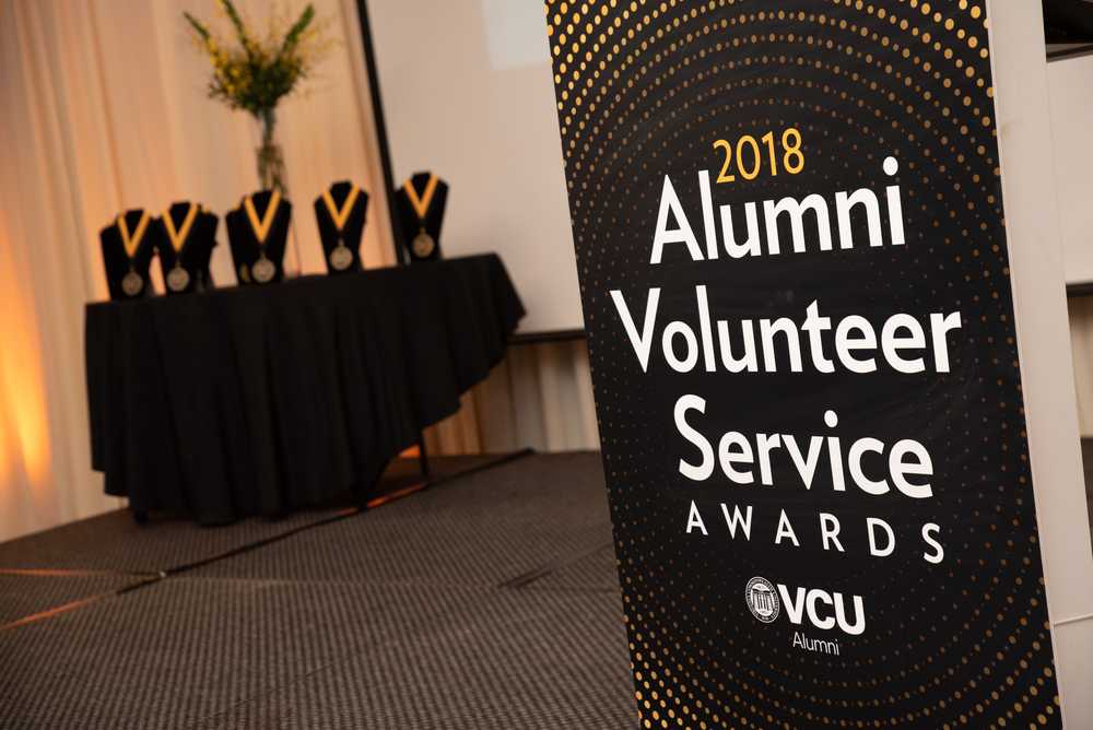 A photo of a sign that says "2018 Alumni Volunteer Service Awards."