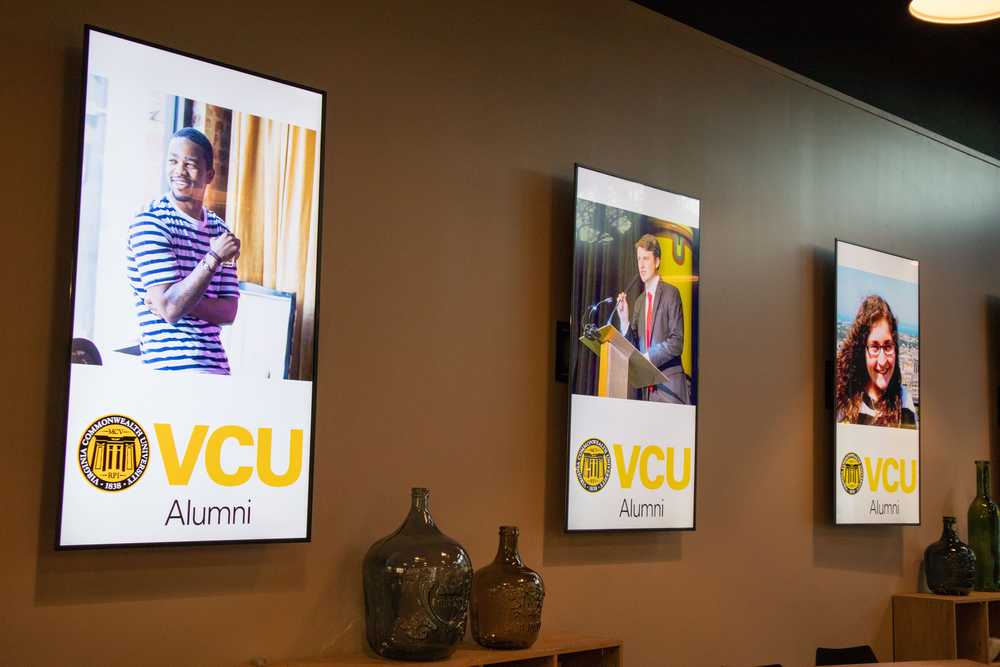 Three screens show off alumni panelists for a speaking event.