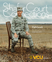 Woman in military camouflage uniform sitting on a chair in a field